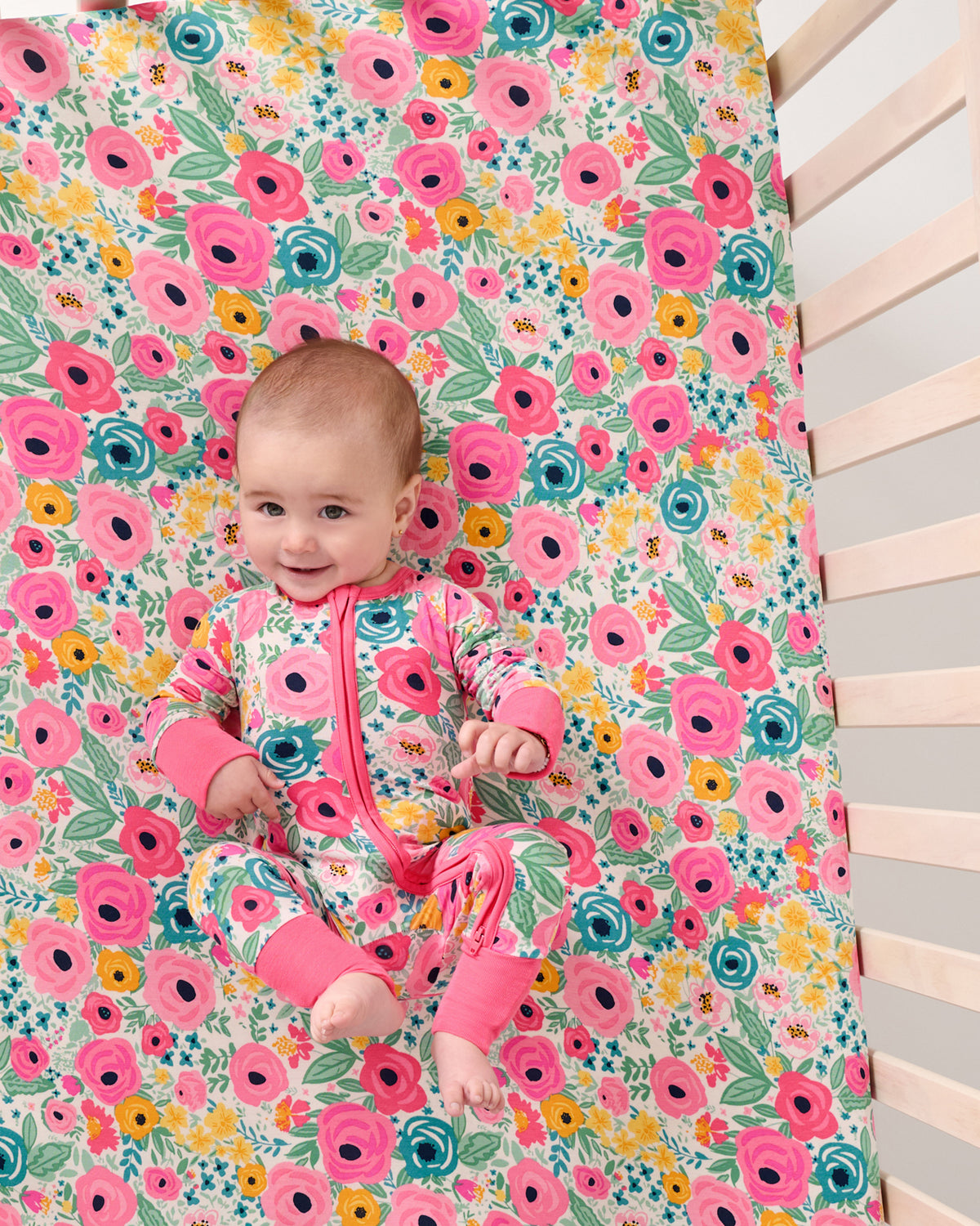 Aerial view of baby laying on the Secret Garden Fitted Crib Sheet