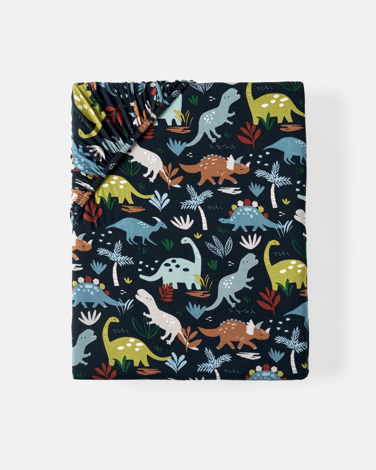 Flat lay of the Navy Jurassic Jungle Fitted Crib Sheet