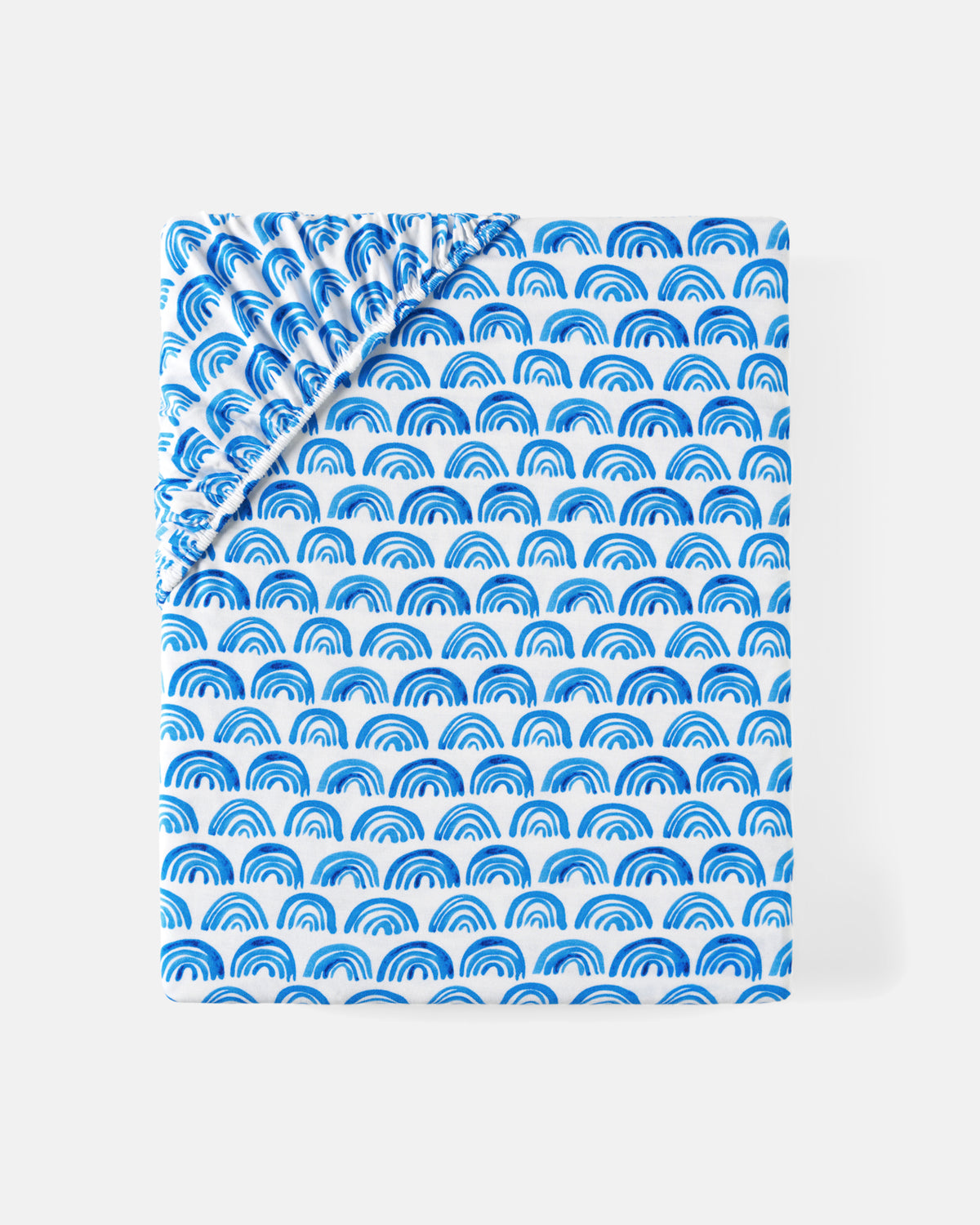 Flat lay of the Blue Rainbows Fitted Crib Sheet