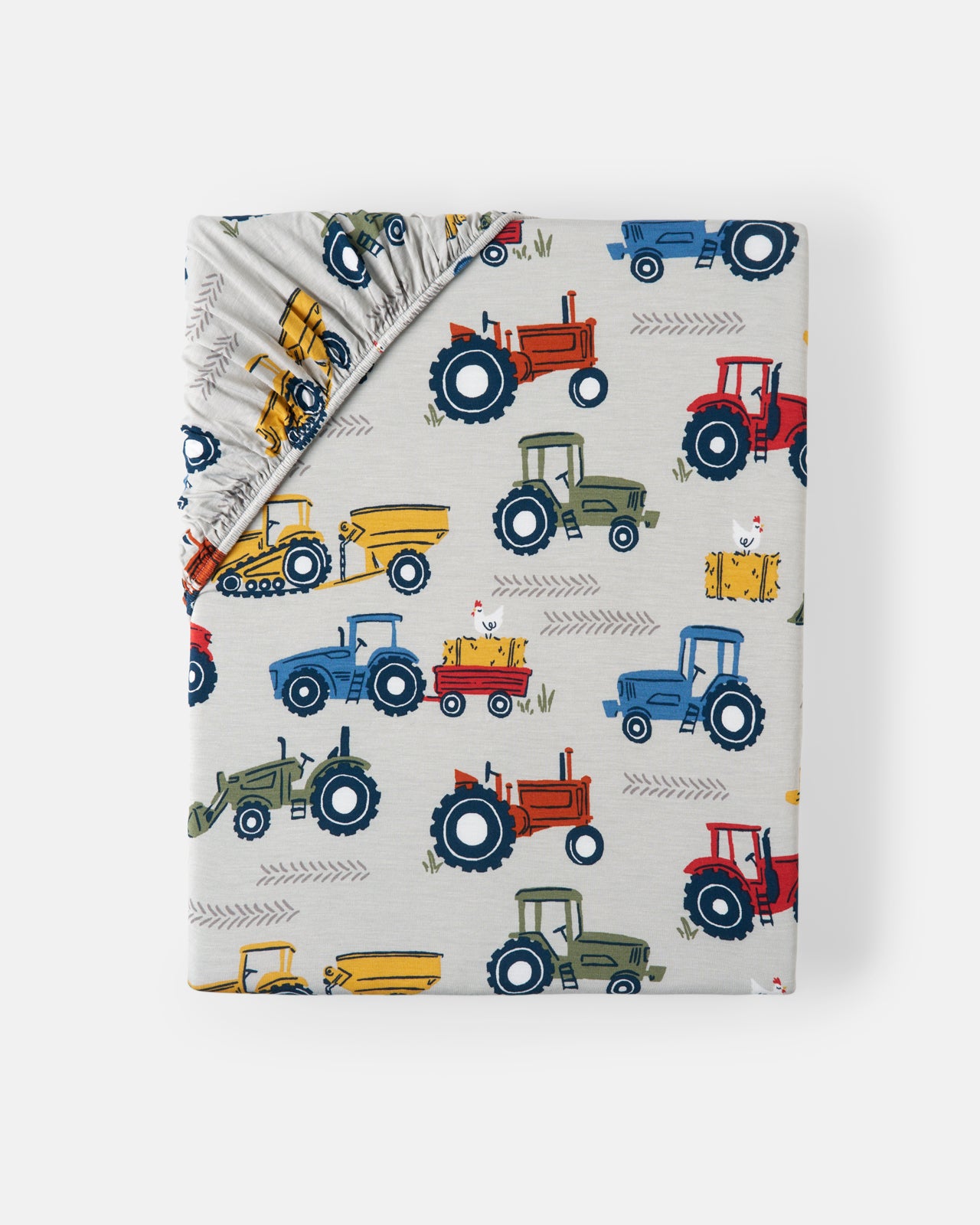 Flat lay of the Tractor Tales Fitted Crib Sheet