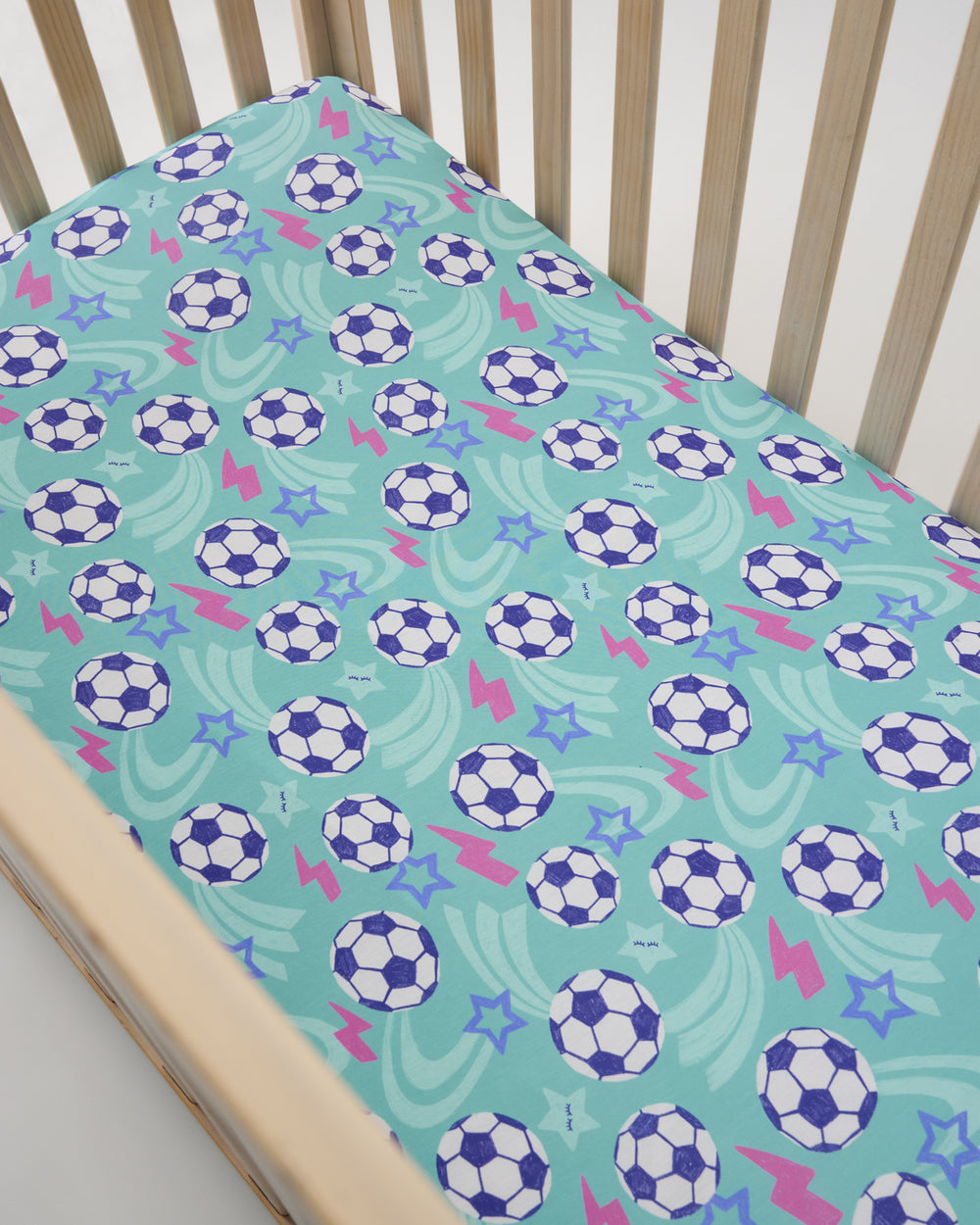 Overhead view of the Aqua Soccer Stars Fitted Crib Sheet