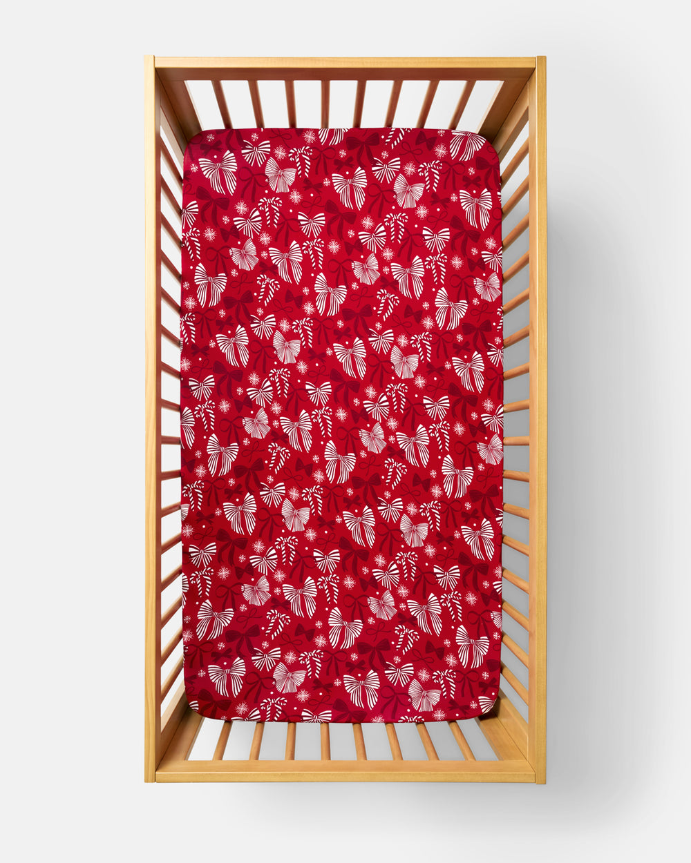 Overhead view of the Holiday Bows Fitted Crib Sheet