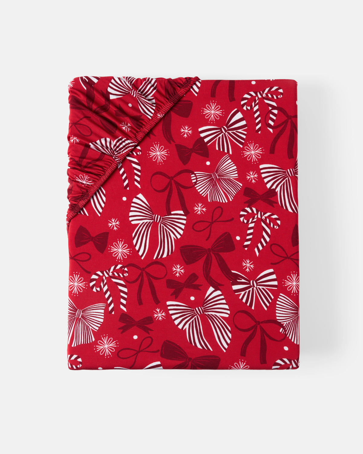 Flat lay of the Holiday Bows Fitted Crib Sheet