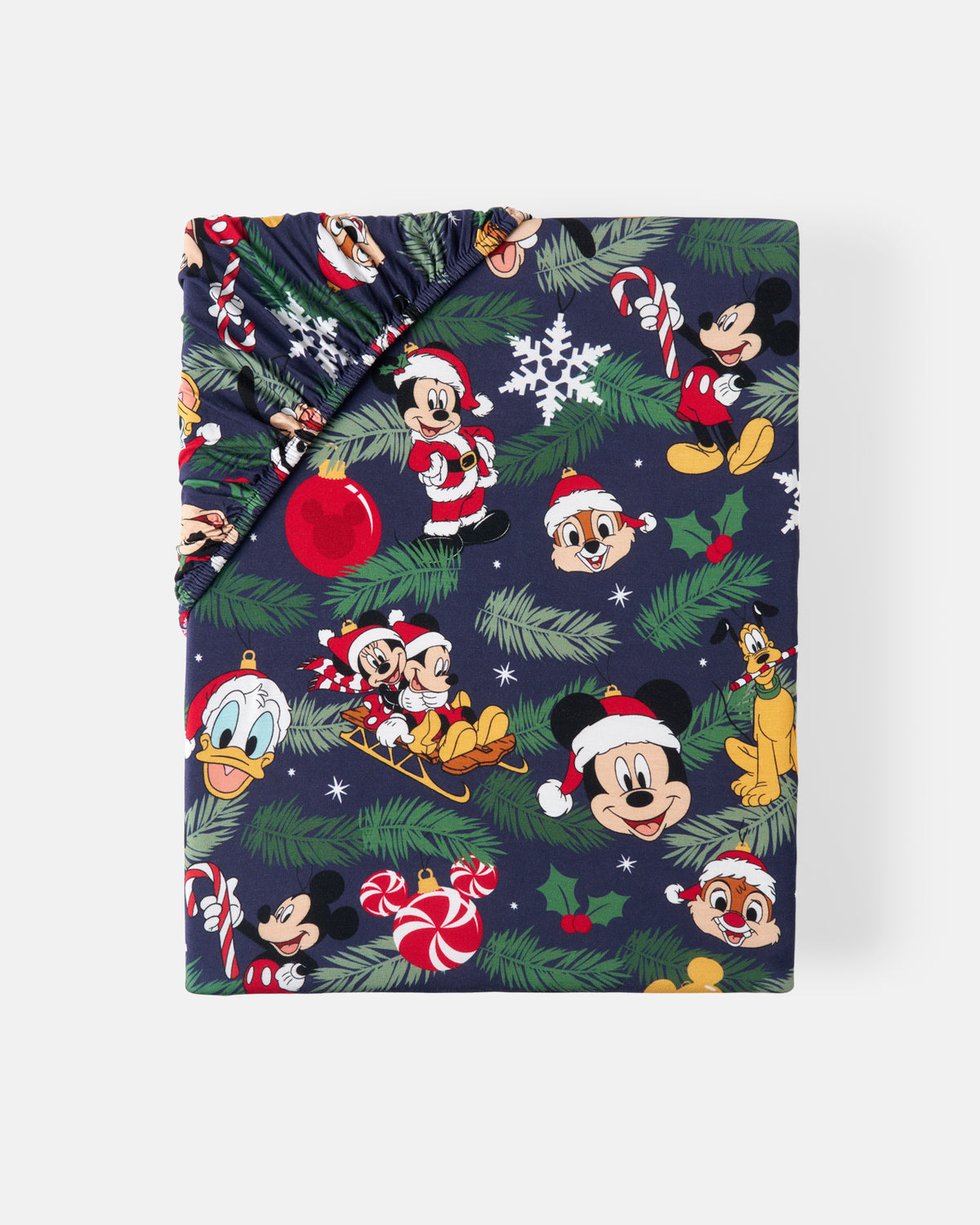 A folded sheet, featuring a festive Christmas print with Mickey Mouse, Donald Duck, Goofy, and Pluto in Santa outfits, set against a dark navy background with pine branches, candy canes, and snowflakes.