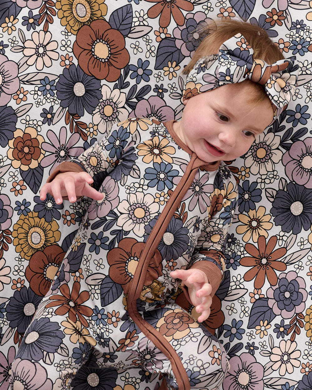 Baby laying on the Wildwood Floral Fitted Crib Sheet