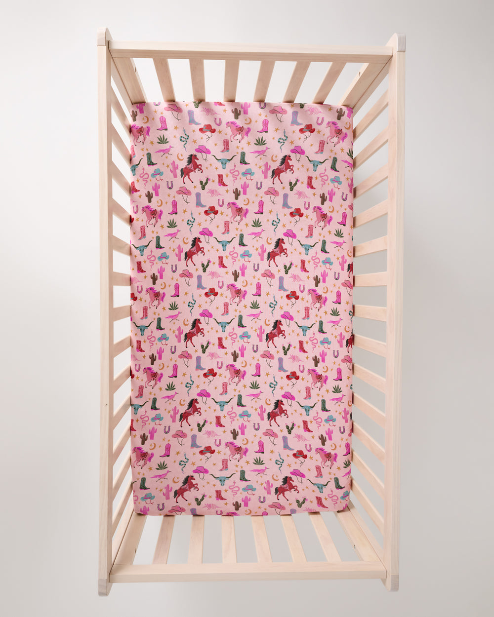 Overhead view of the Pink Rancher Roundup Fitted Crib Sheet