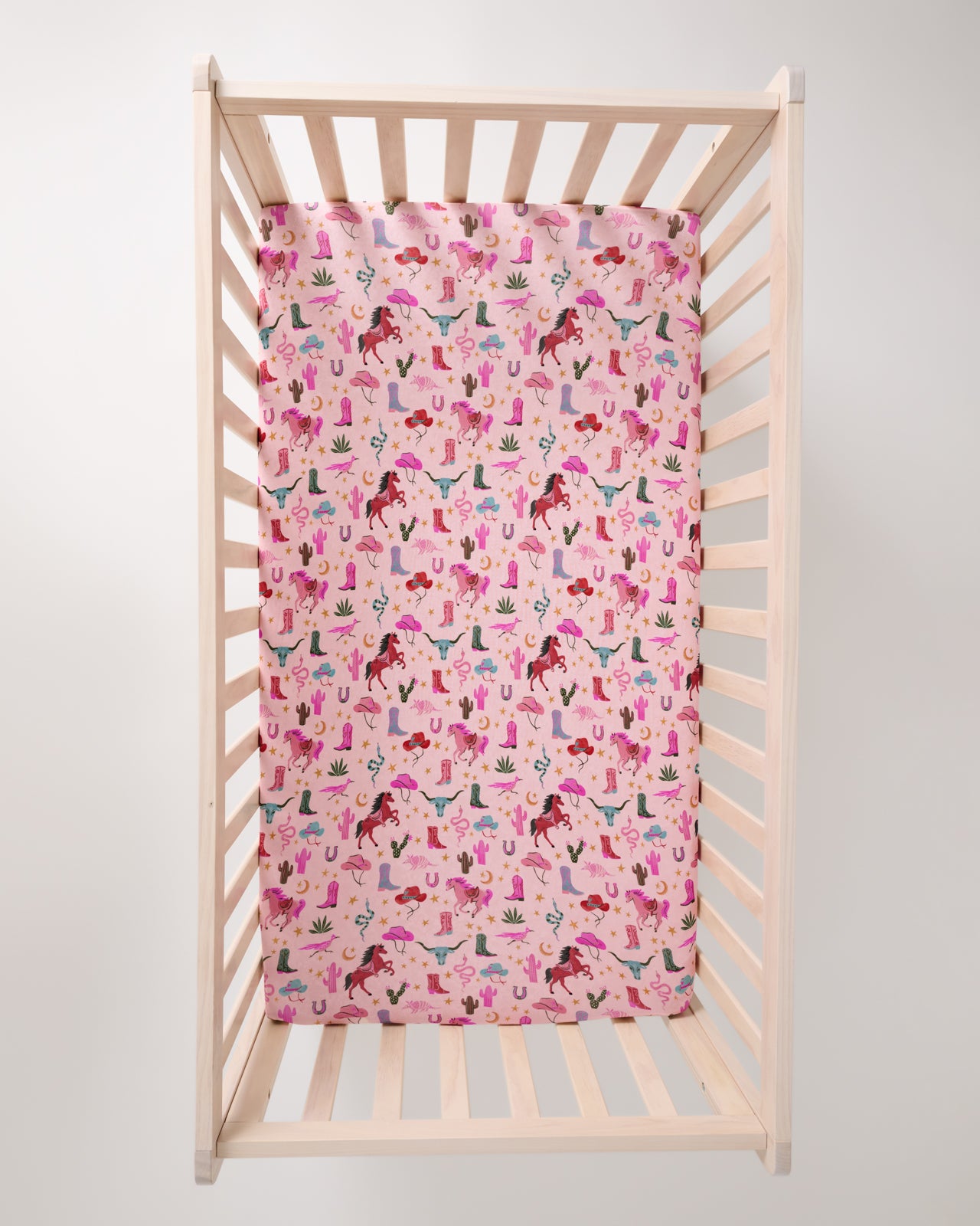 Overhead view of the Pink Rancher Roundup Fitted Crib Sheet