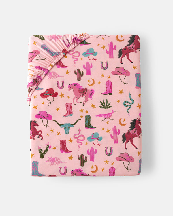 Flat lay of the Pink Rancher Roundup Fitted Crib Sheet
