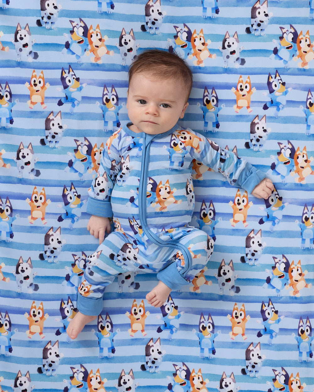 Close up of baby laying on the Bluey Dance All Day Fitted Crib Sheet