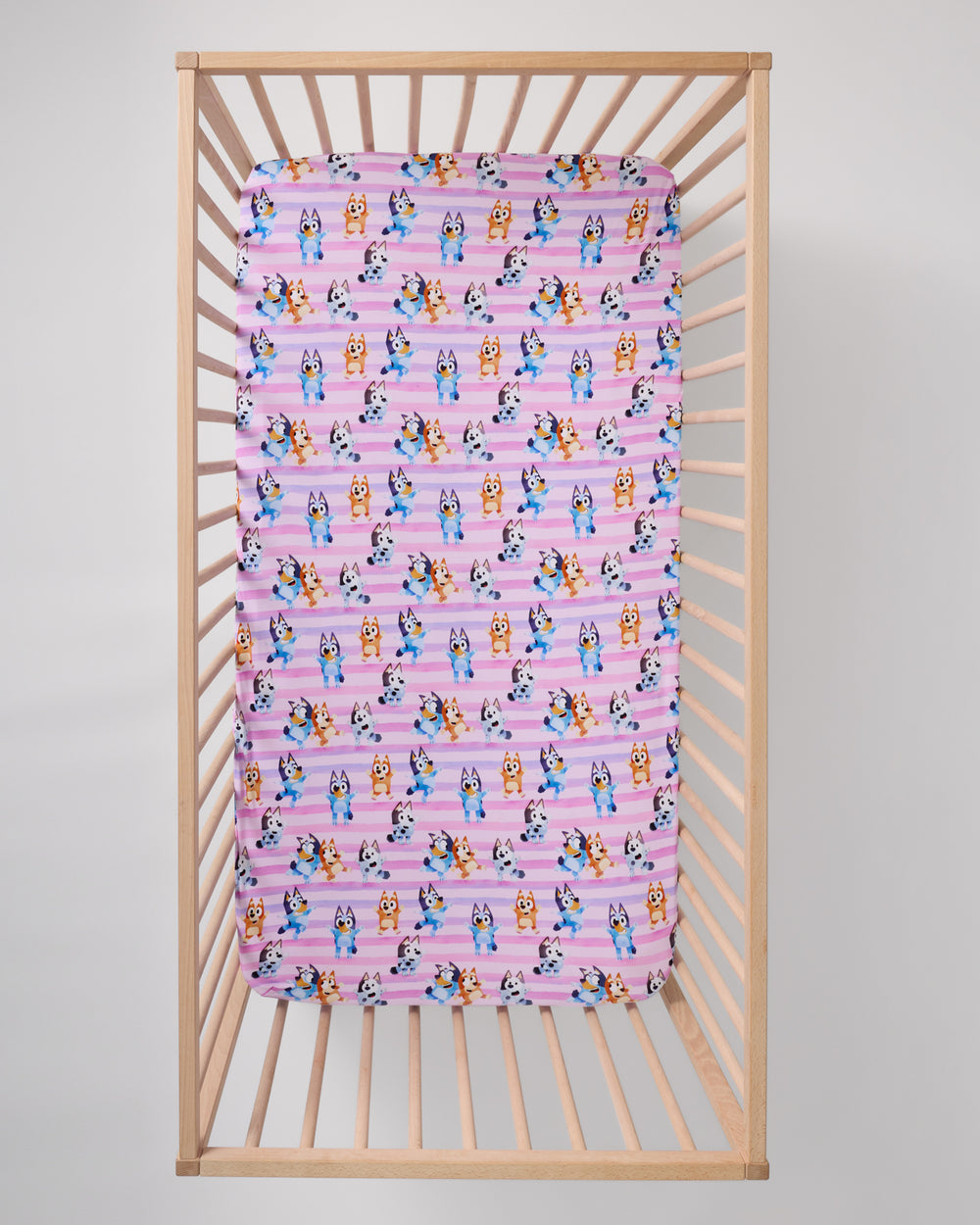Overhead view of the Pink Bluey Dance All Day Fitted Crib Sheet