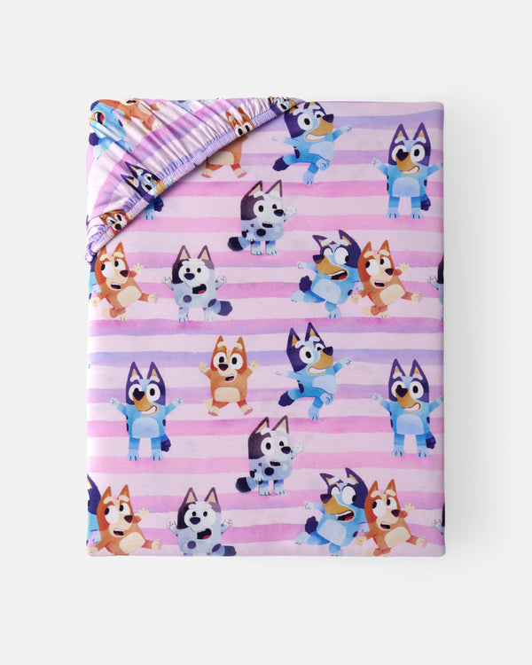 Flat lay of the Pink Bluey Dance All Day Fitted Crib Sheet