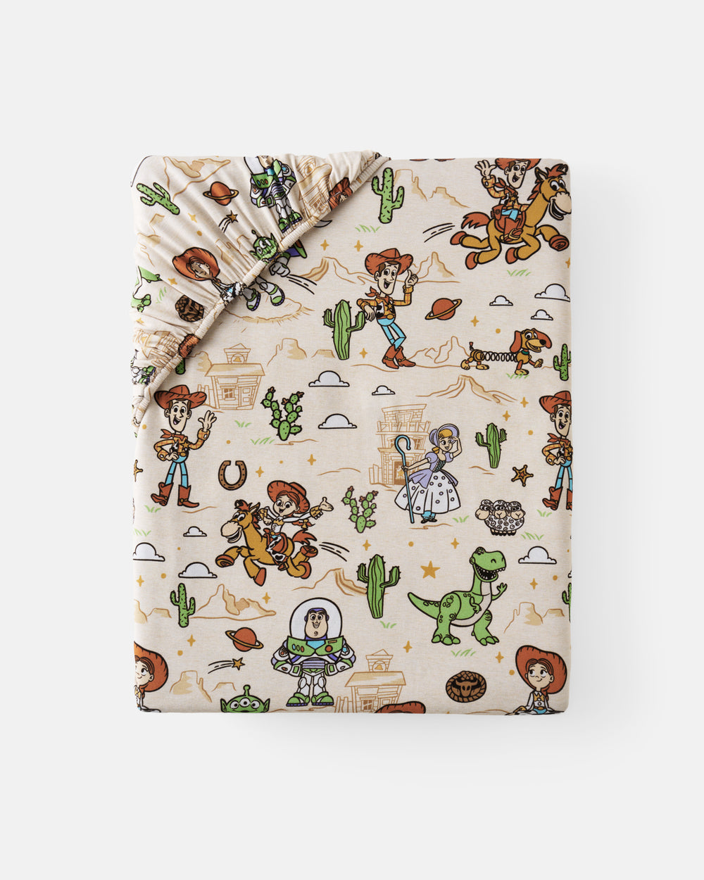 Flat lay of the Disney & Pixar Woody's Wild West Fitted Crib Sheet