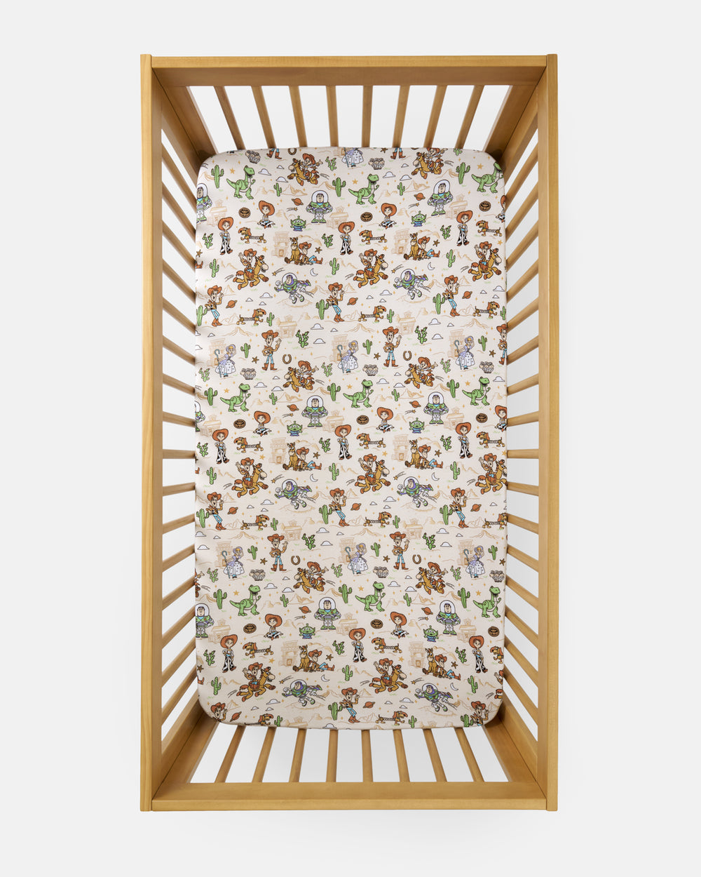 Overhead view of the Disney & Pixar Woody's Wild West Fitted Crib Sheet