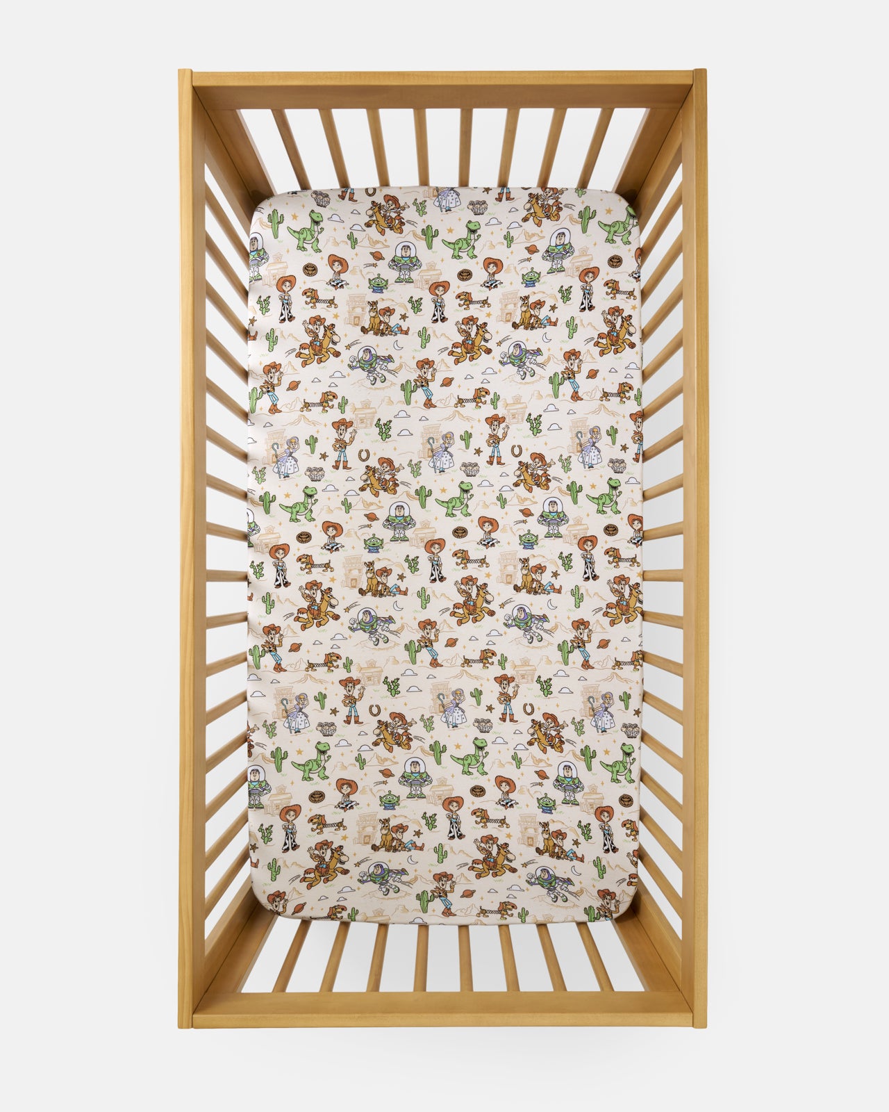 Overhead view of the Disney & Pixar Woody's Wild West Fitted Crib Sheet