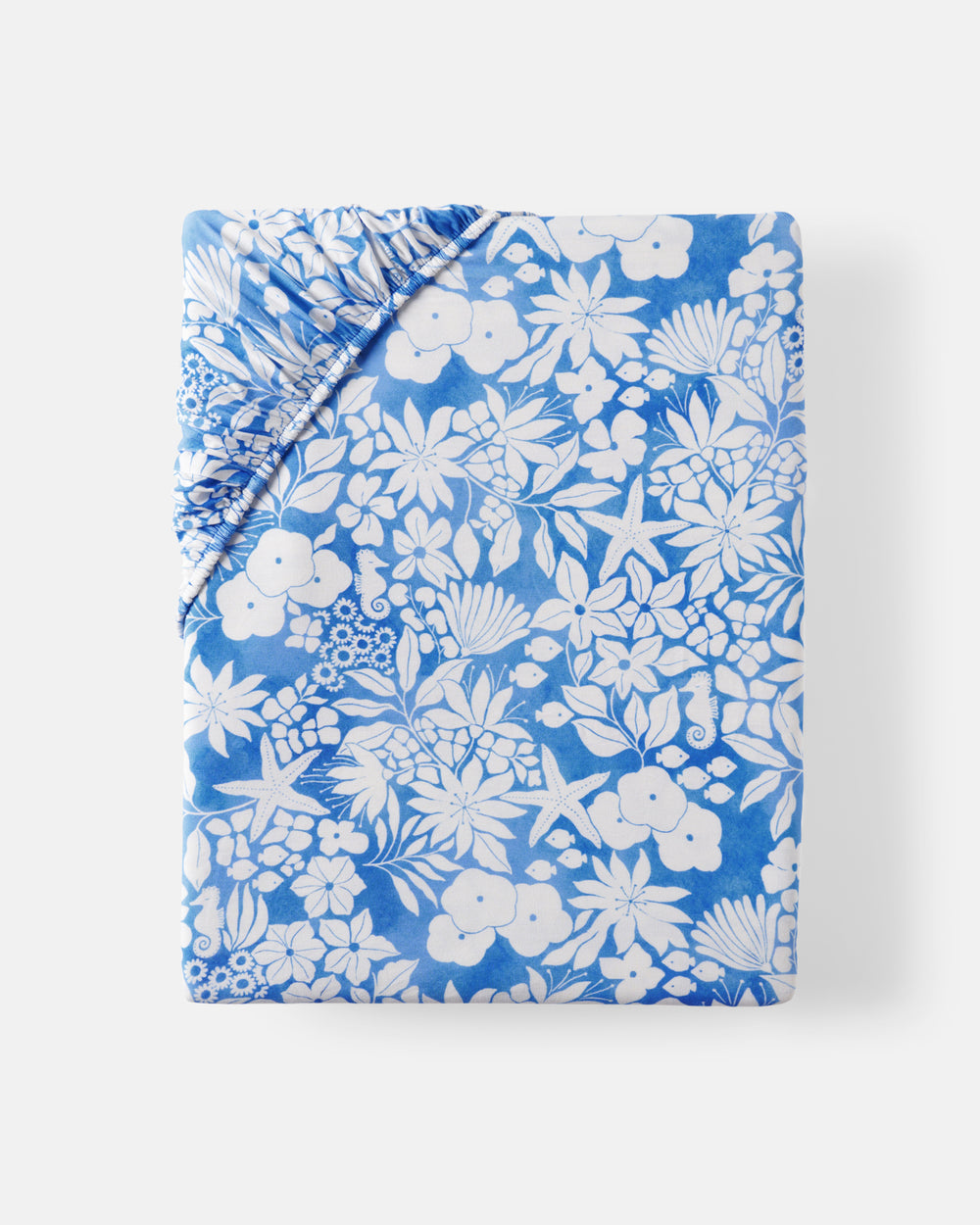 Flat lay of the Azure Garden Fitted Crib Sheet