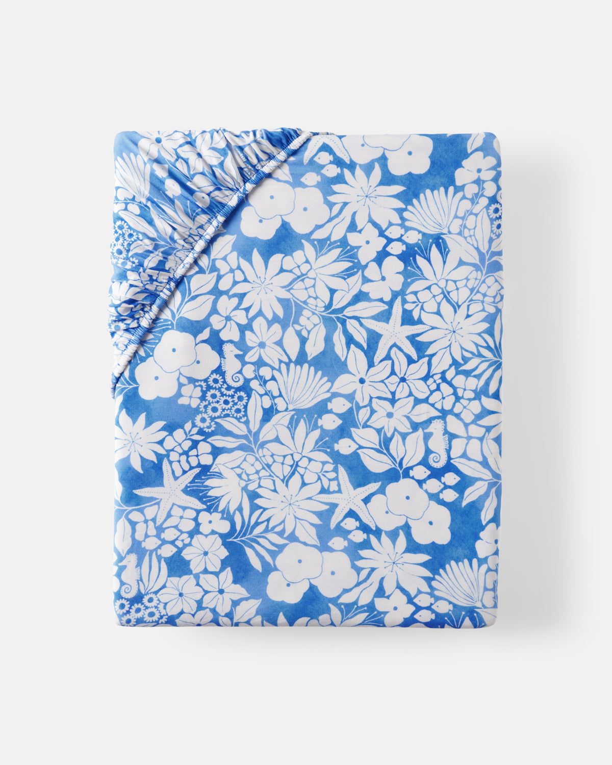 Flat lay of the Azure Garden Fitted Crib Sheet