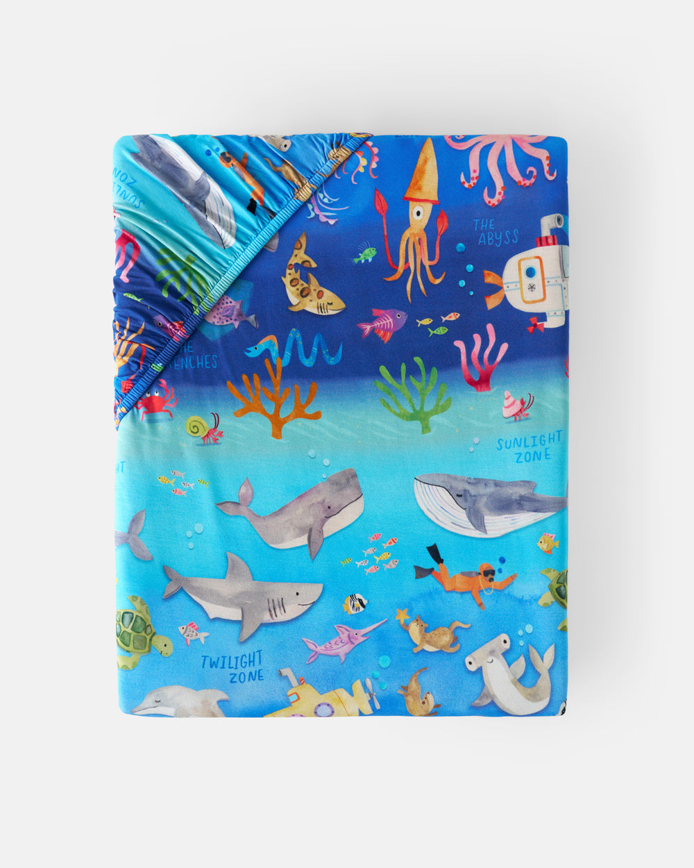 Flat lay of the Underwater Discovery Fitted Crib Sheet