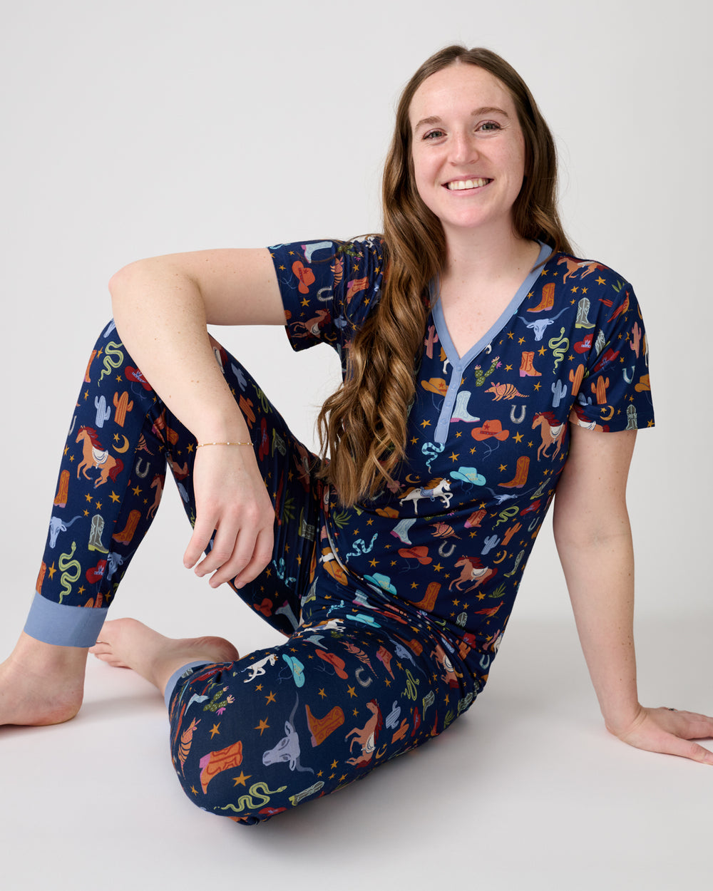Sitting woman wearing the Blue Rancher Roundup Women's Short Sleeve Pajama Top and Pants