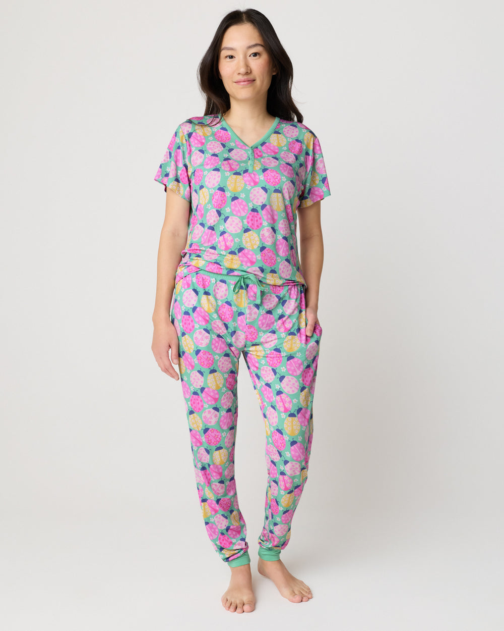 Woman wearing the Ladybug Meadow Women's Pajama Pants and Short Sleeve Top