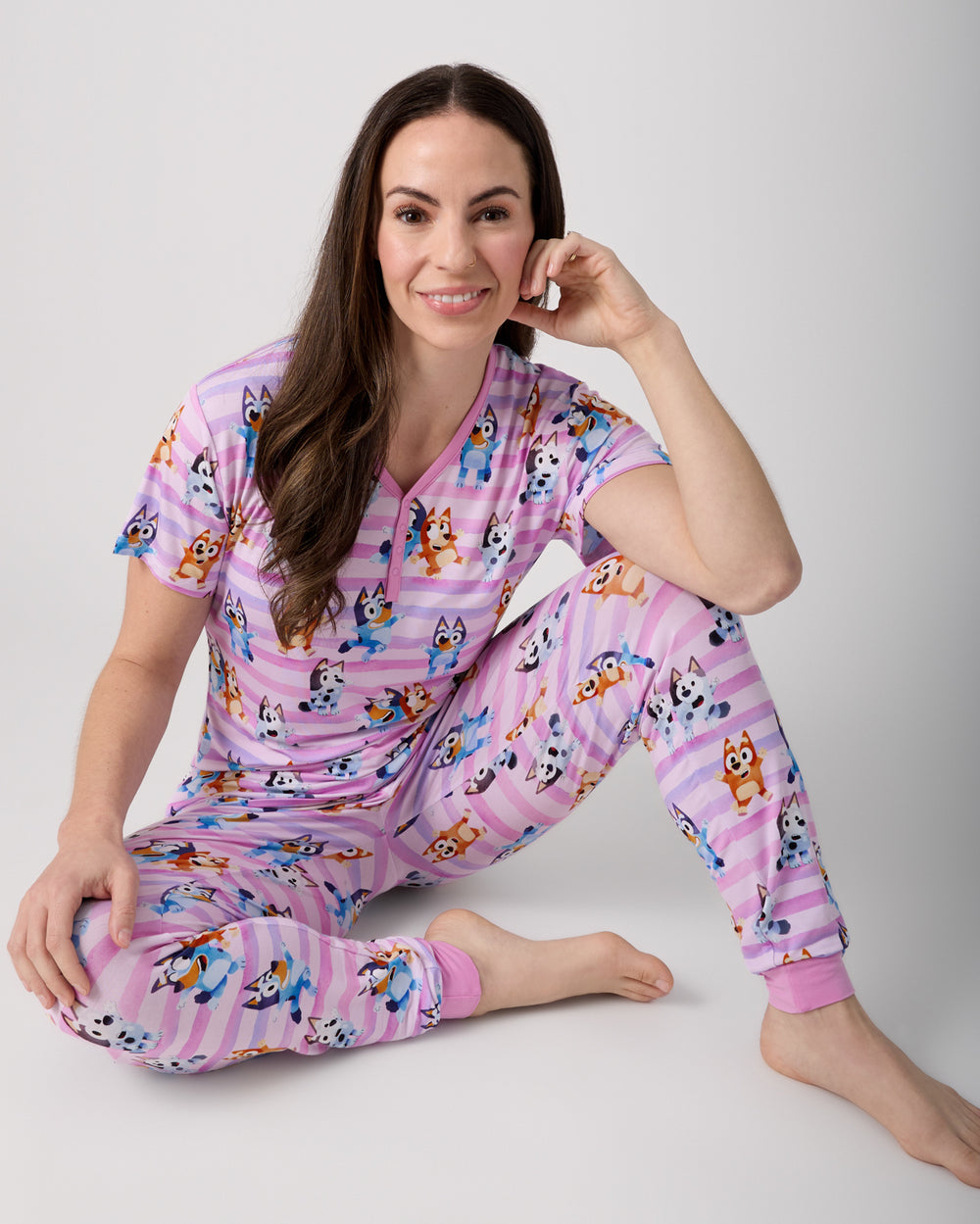 Sitting woman wearing the Pink Bluey Dance All Day Women's Pajama Pants and Shirt
