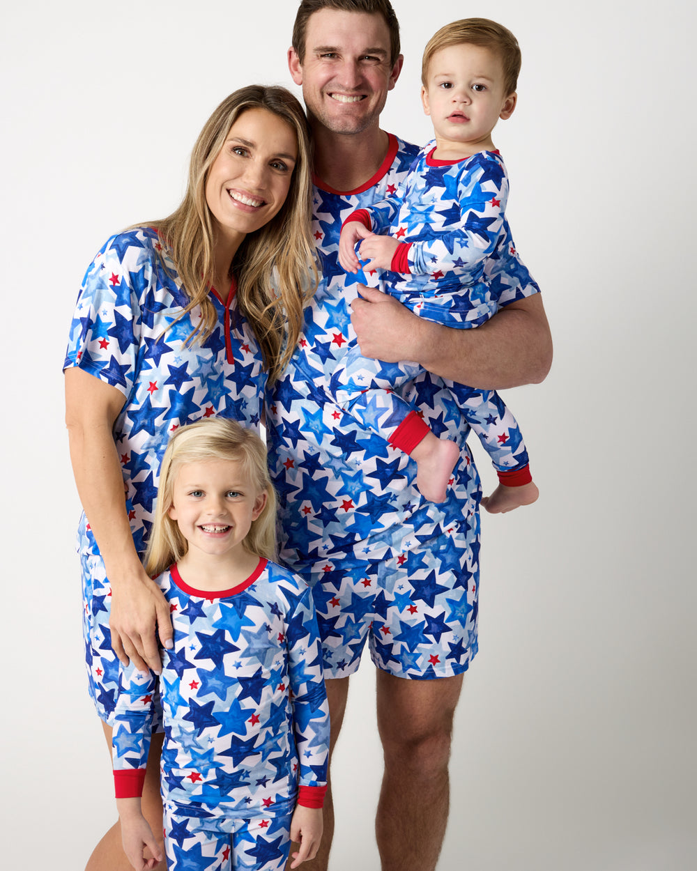 Family of four wearing the Starry Splash Fourth of July Pajamas