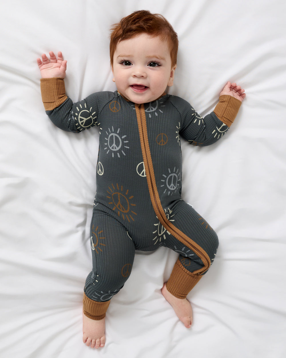 Aerial view of baby wearing the Peace & Love Ribbed Zippy