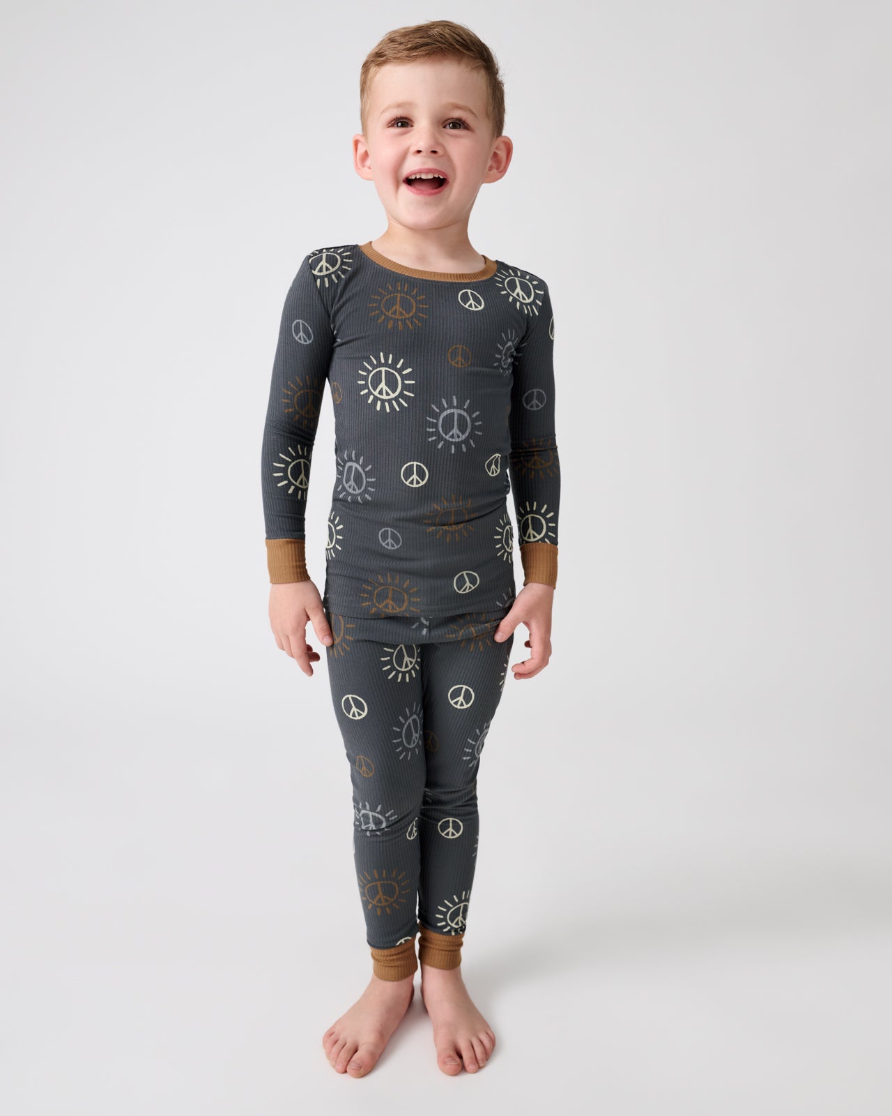 Standing boy wearing the Peace & Love Ribbed Two-Piece Pajama Set