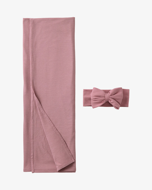 Flat lay of the Rosewood Ribbed Swaddle & Luxe Bow Headband Set