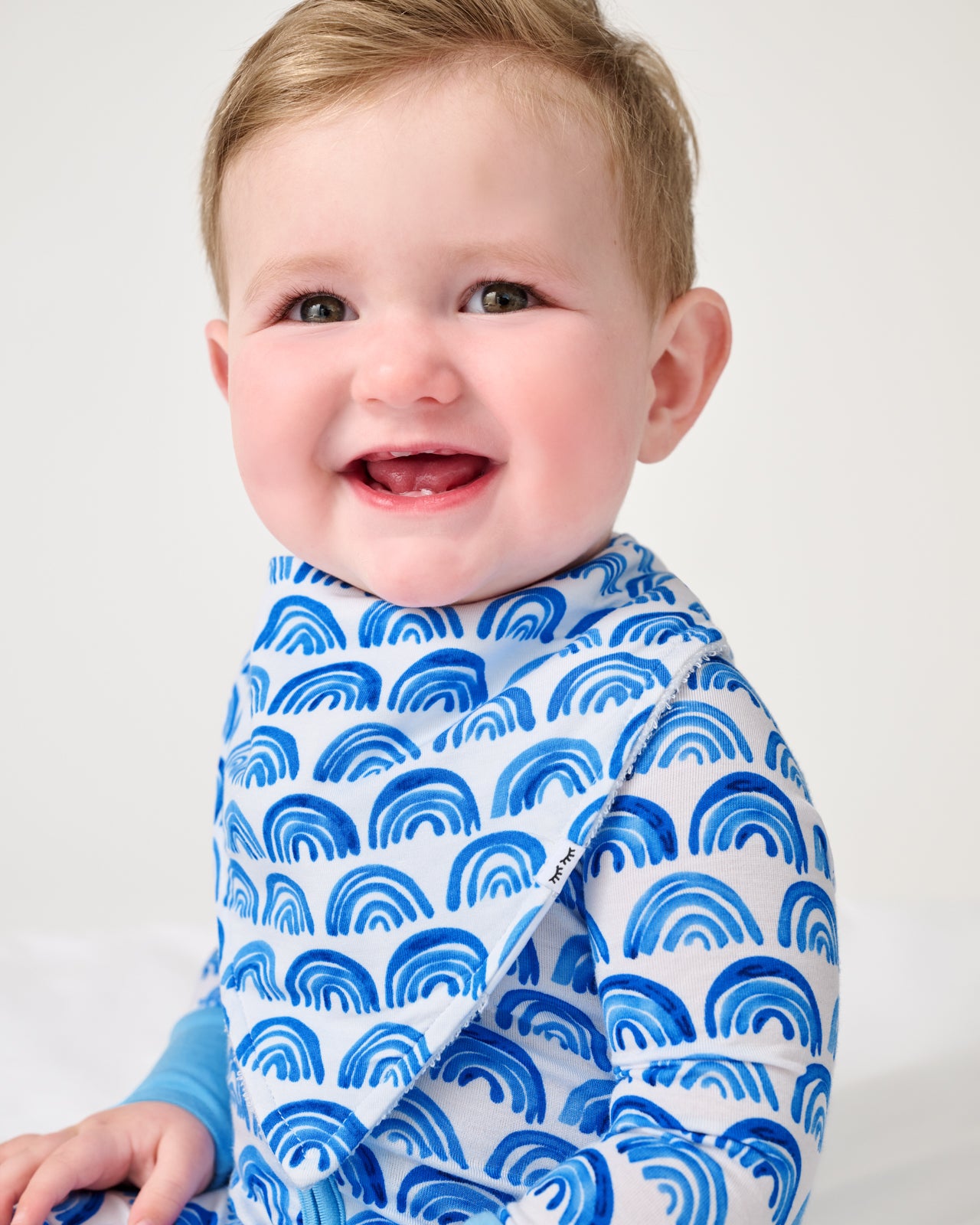 Close up of baby wearing the Blue Rainbows Bandana Bib