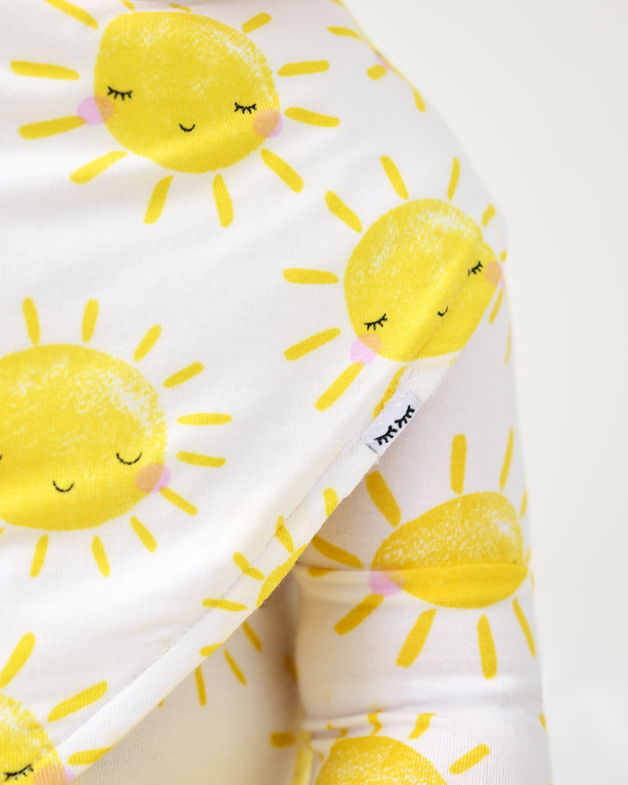 Close up of the Little Sleepies logo on the Sunshine Bandana Bib