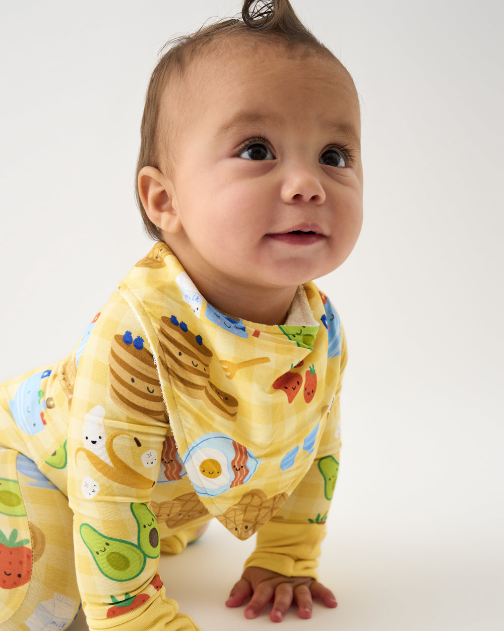 Crawling baby wearing the Breakfast Bunch Bandana Bib