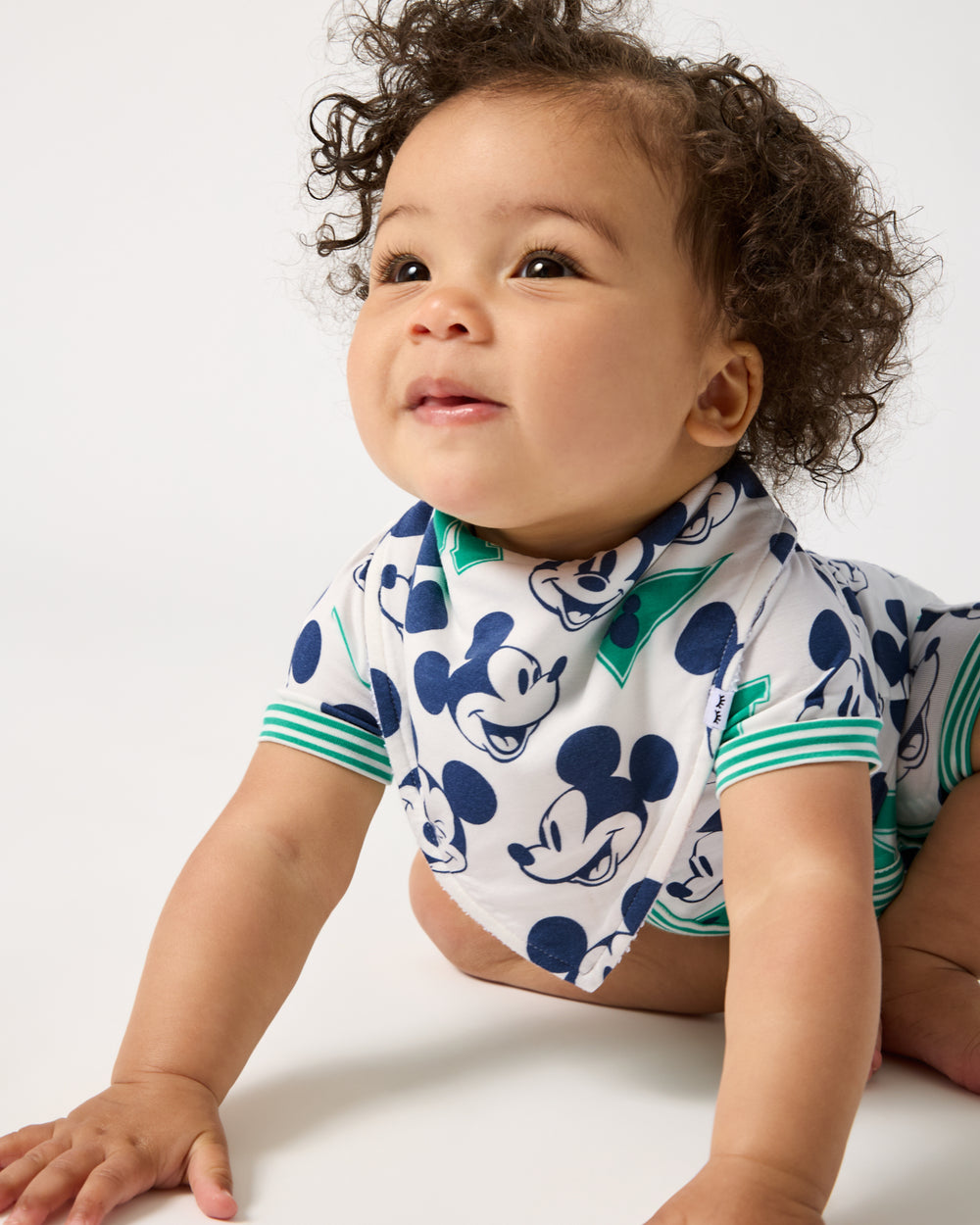 Crawling baby wearing the Disney Varsity Mickey Mouse Bandana Bib