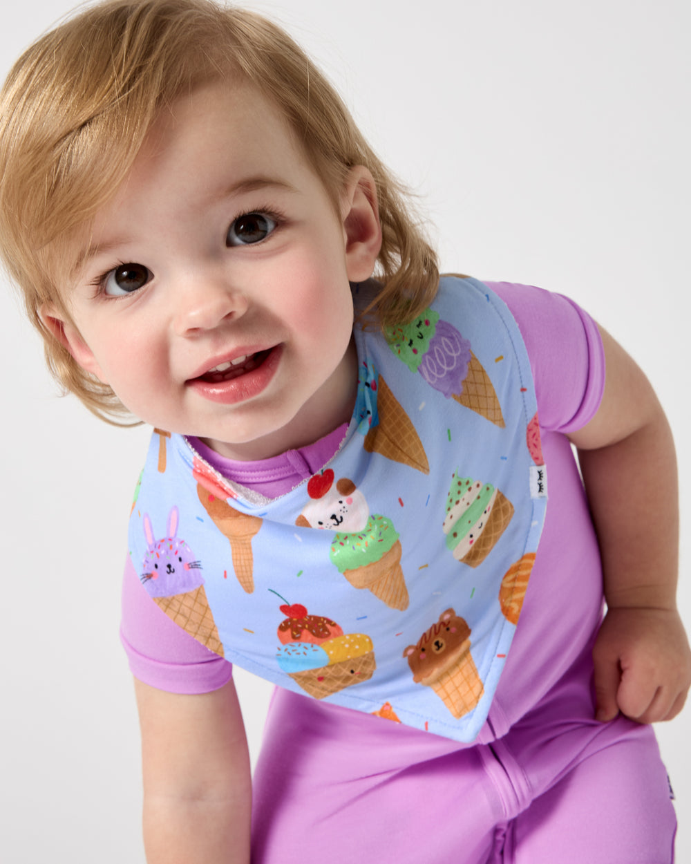 Baby wearing the Scoop Squad Bandana Bib