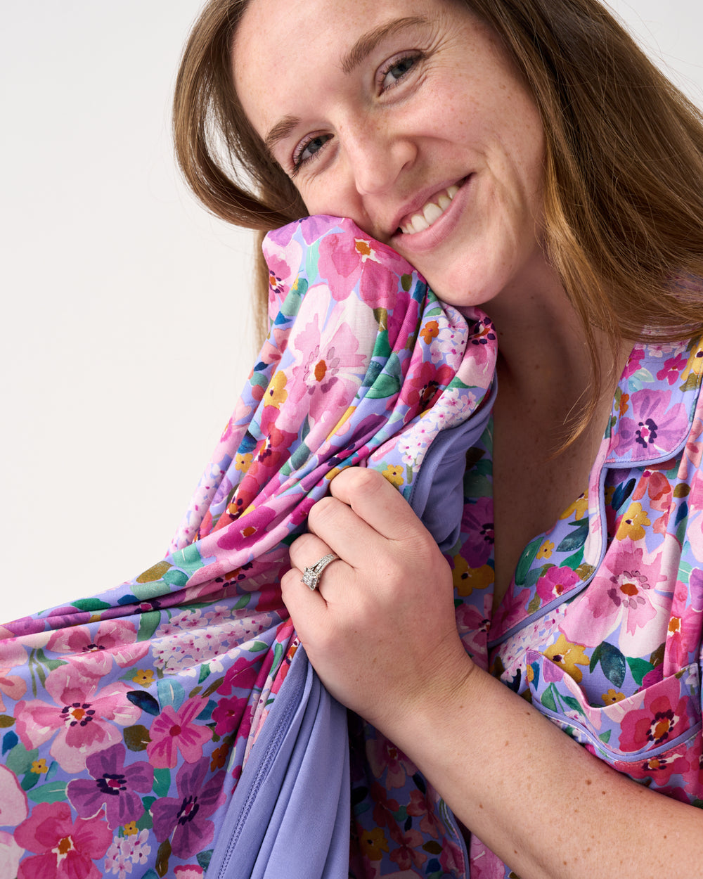Close up of woman snuggled with the Sweet Sprigs Oversized Cloud Blanket®