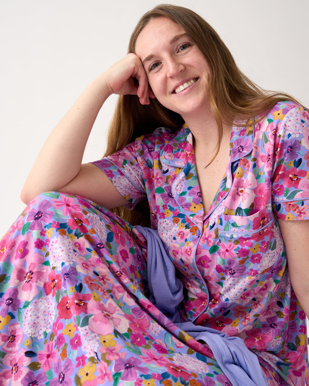 Woman covered in the Sweet Sprigs Oversized Cloud Blanket®