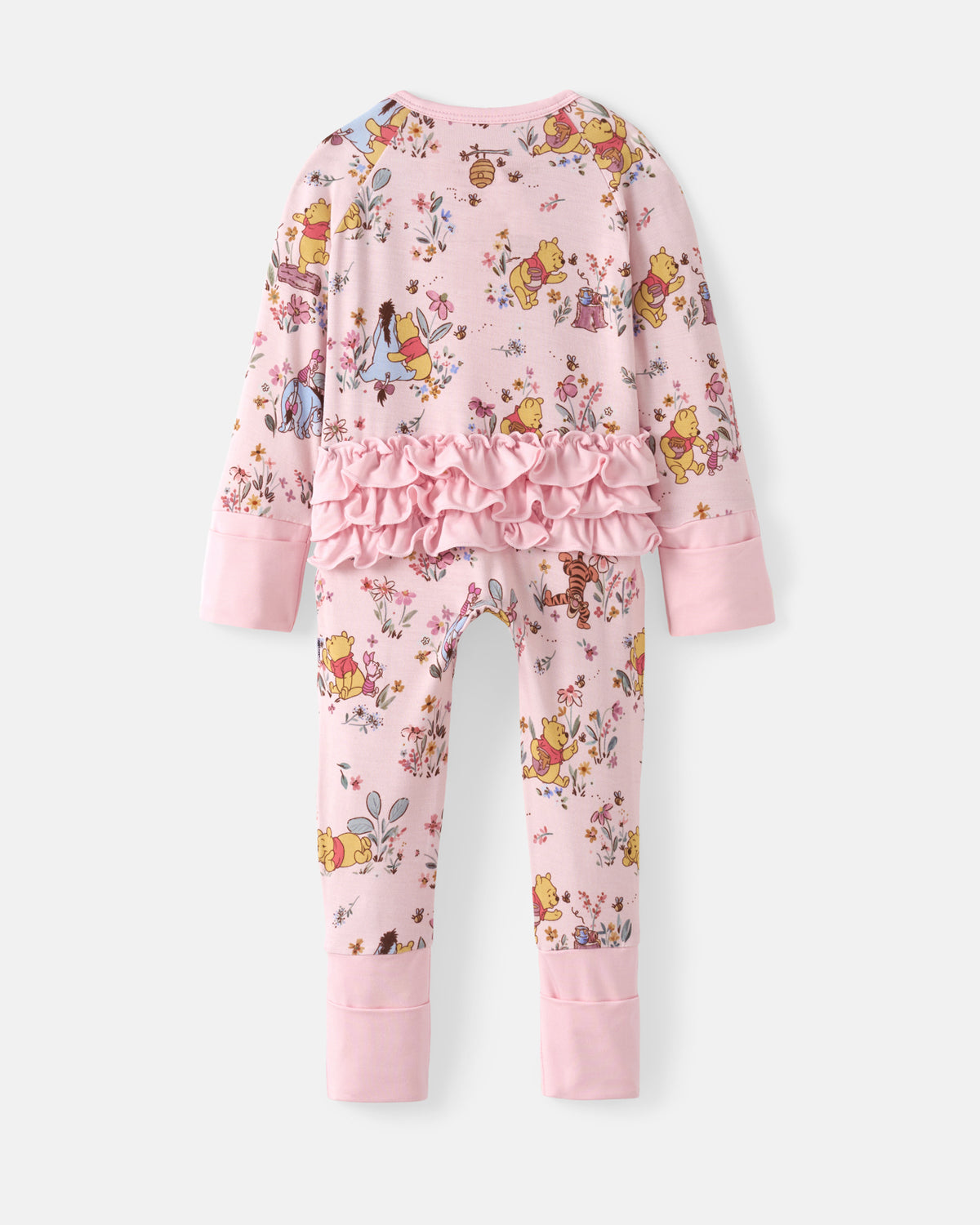 A children's long-sleeve pajama set in light pink, featuring an all-over Winnie the Pooh and Disney princess print, a ruffled waist detail, and solid pink cuffs and hem.