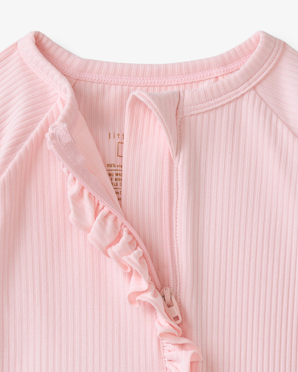 Close up of the zipper detail on the Prima Pink Ribbed Ruffle Zippy