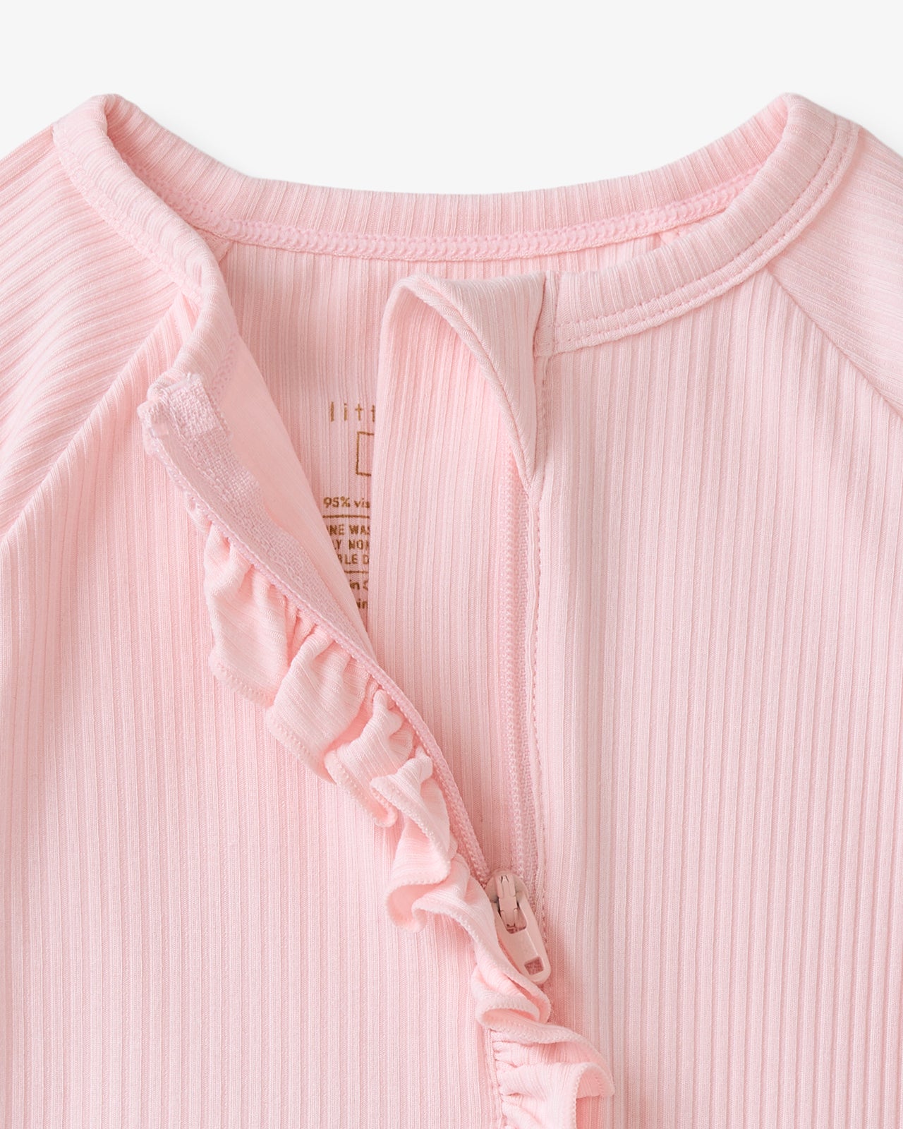 Close up of the zipper detail on the Prima Pink Ribbed Ruffle Zippy