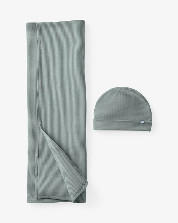 Flat lay of the Willow Baby Ribbed Swaddle & Infant Beanie Set