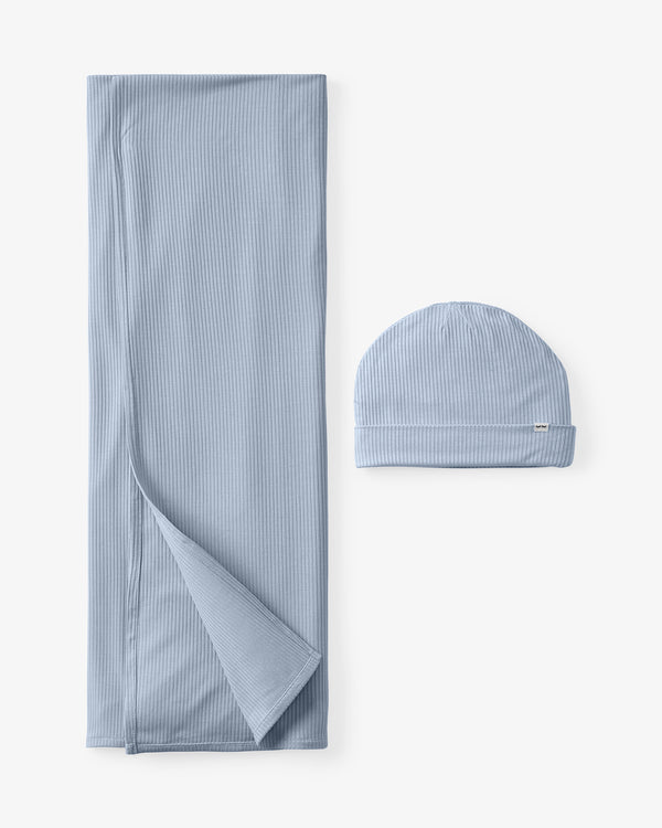 Flat lay of the Light Fog Baby Ribbed Swaddle & Infant Beanie Set