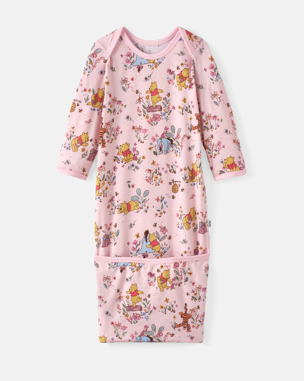 A pink long-sleeve baby sleep sack featuring an all-over Winnie the Pooh and friends floral cartoon print, with a front pocket, shown flat on a light gray background.