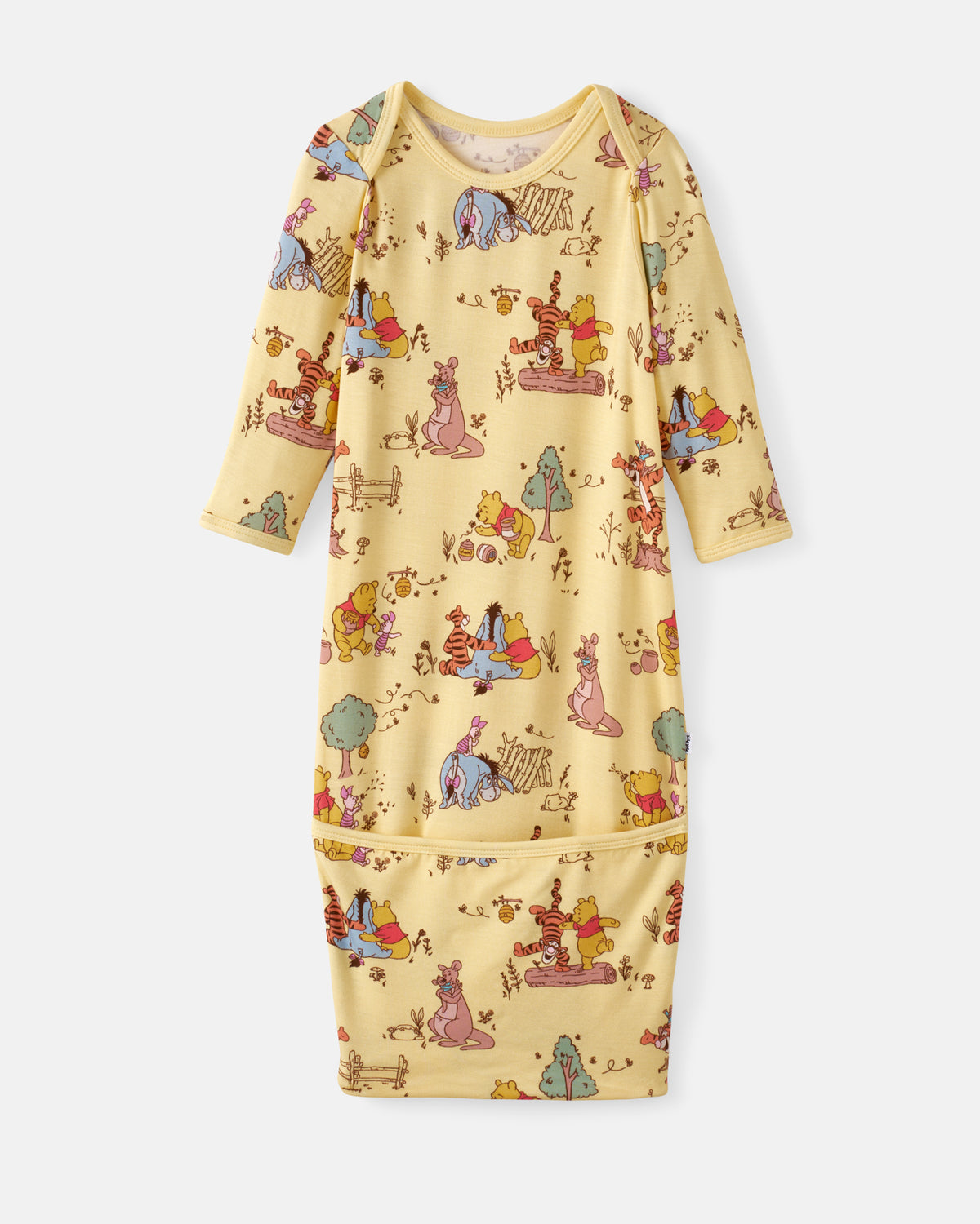 A long-sleeve baby sleep sack in pale yellow with an all-over Winnie the Pooh print, featuring a front kangaroo pocket and adjustable shoulder straps, shown flat on a light gray background.