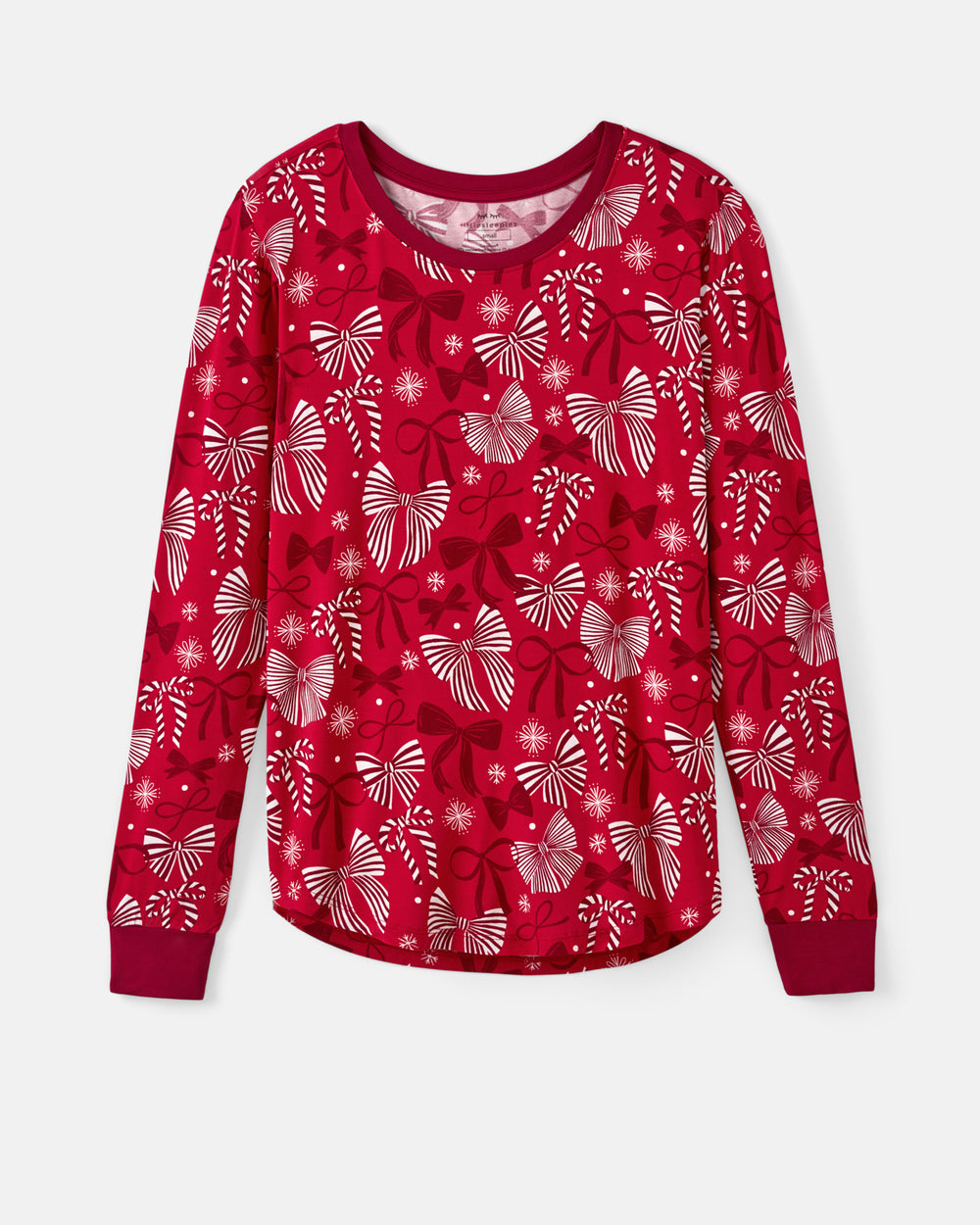 A long-sleeve crewneck top in bright red with an all-over festive print of white and dark red bows and snowflakes, displayed flat against a light background.