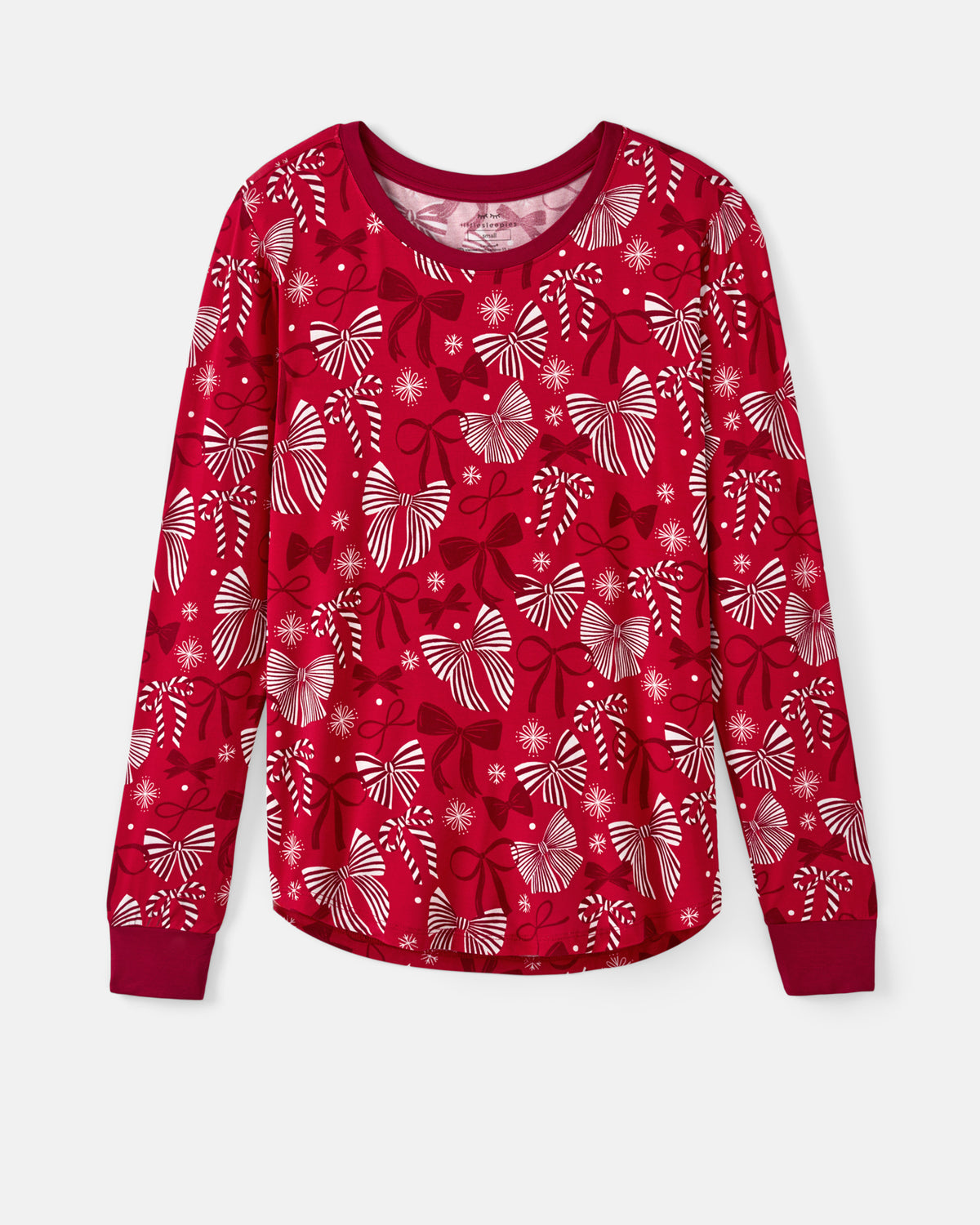 A long-sleeve crewneck top in bright red with an all-over festive print of white and dark red bows and snowflakes, displayed flat against a light background.