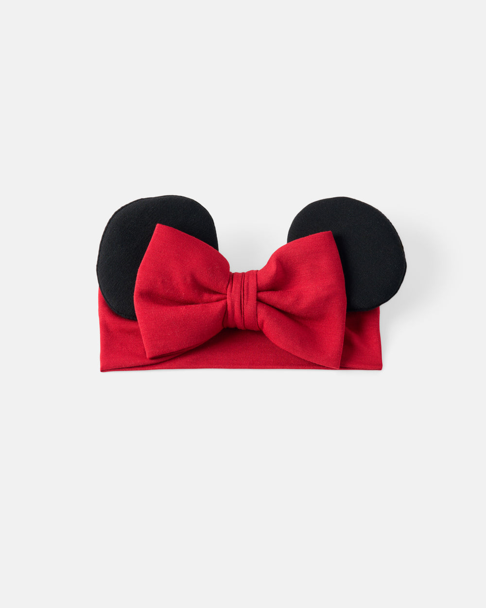 A red fabric headband with a large red bow and two black mouse-ear shapes on top, photographed on a plain light gray background.