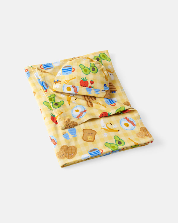 Flat lay of the Breakfast Bunch Swaddle & Hat Set