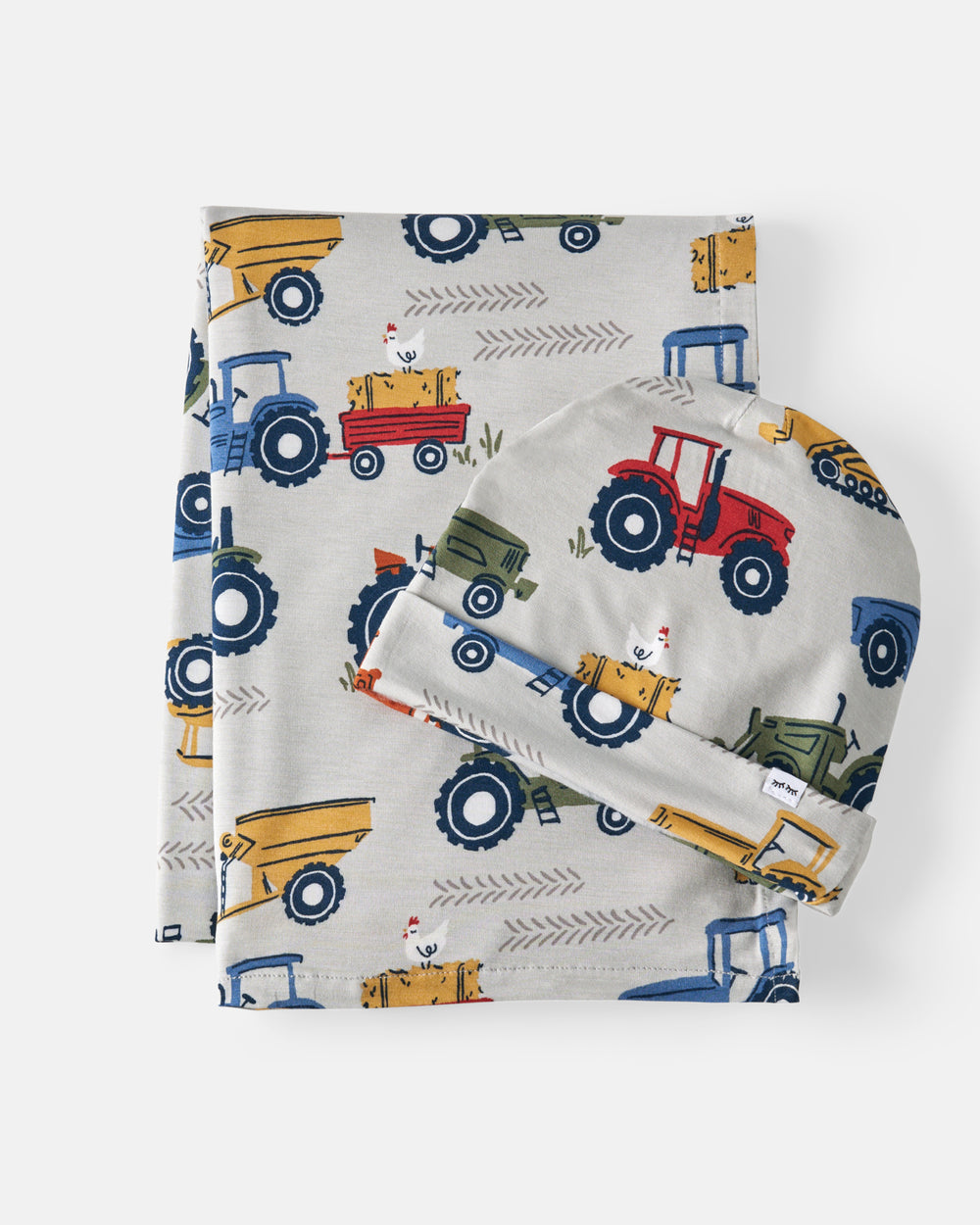 Flat lay of the Tractor Tales Swaddle & Beanie Set