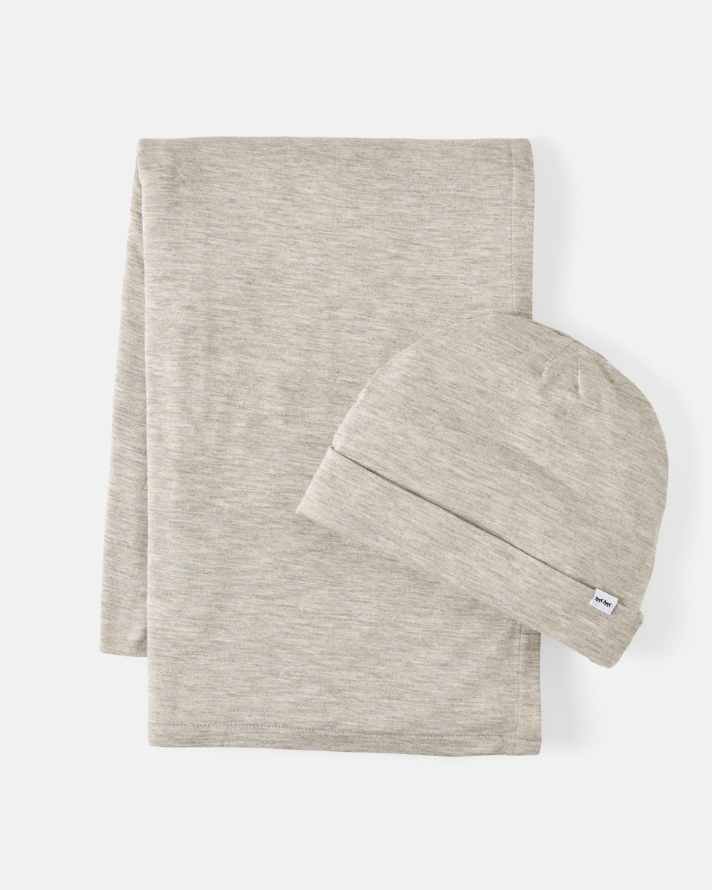 A baby blanket and matching beanie set in a light heathered oatmeal beige color, presented on a clean off-white background.
