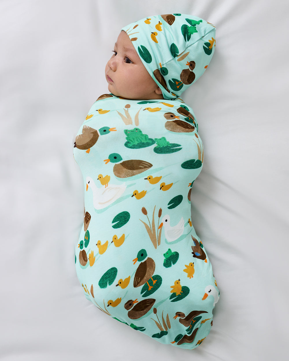 Aerial view of baby swaddles in the Puddle Jumpers Swaddle & Beanie Set