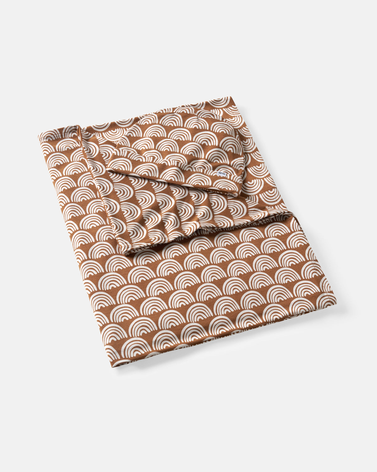 Flat lay of the Rust Rainbows Swaddle & Beanie Set